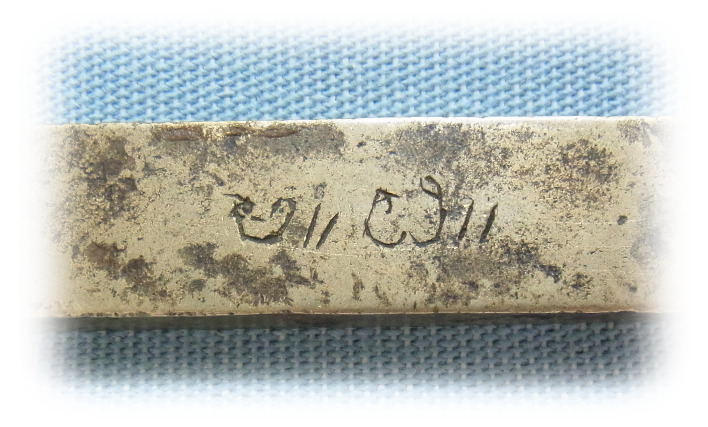 Author's signature engraved on the jewelry die.